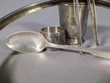a lot of silver spoons and spoon rest on the table