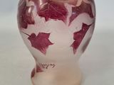 a small vase with a red and white design on it
