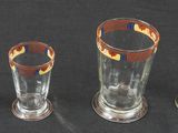 four glass vases sitting next to each other on a table