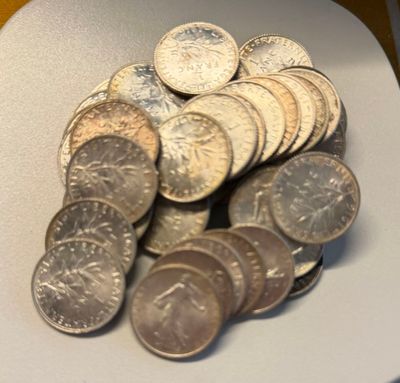 a pile of coins sitting on a plate on a table