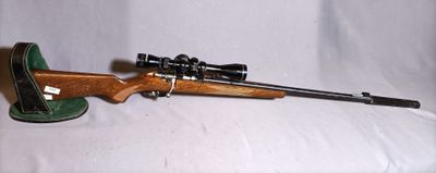 a picture of a toy rifle with a scope on a white background