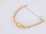 an image of a gold bracelet on a white surface