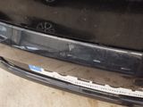 a close up of the bumper of a car that has been dented