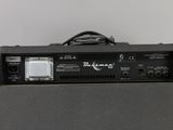 the back of a guitar amplifier sitting on top of a table