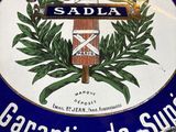 a blue and white sign with a picture of a coat of arms on it
