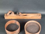 two wooden bowls and a plane on a black surface