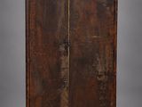 an old wooden cabinet with a vase on top of it