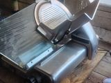 a large slicer that is sitting on a wooden table