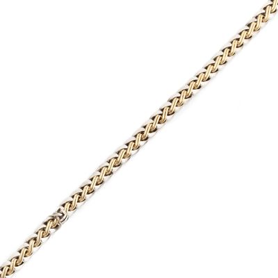 a close up of a gold chain on a white background