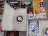 a person holding a nintendo wii game in a box