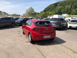 a red car that is parked in a parking lot