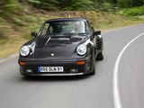 a black car that is driving down the road