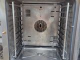 a silver oven with a door open in a kitchen