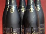 six bottles of brixet champagne on a red background