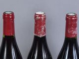 three bottles of wine sitting next to each other on a table