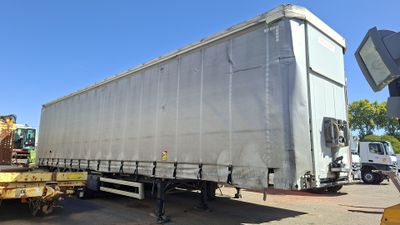 a truck that is parked in a lot with other trucks in the background