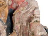 an old statue of a woman sitting on a rock next to a statue of a man