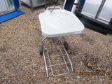 a white sink sitting on top of a metal stand
