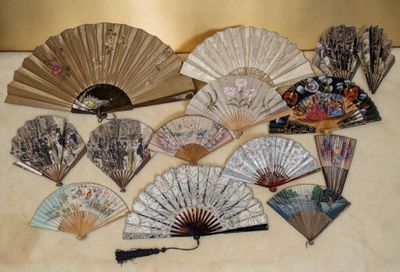 many different types of hand fans on the table