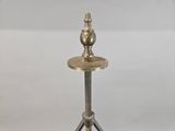 an image of a silver candle holder on a tripod stand