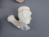 a small statue of a man with a pipe on a table
