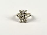 a close up of a diamond ring on a white surface