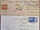 two envelopes with stamps and signatures are sitting on a table