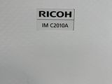 a close up of a ricoh machine on a table