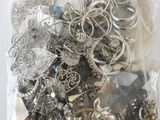 a bag full of silver and silver jewelry on a table