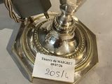 a silver vase that has a tag on it
