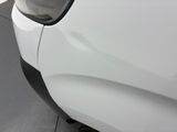 the rear end of a white car with a black bumper
