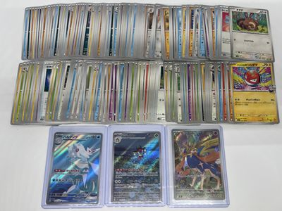 a lot of different pokemon cards on the table