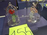 many glass vases with flowers inside of them on a table