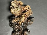 a small figurine of a teddy bear made out of nuts