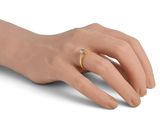 an image of a woman ' s hand with a gold ring on it