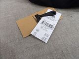 a price tag on a piece of luggage on a couch