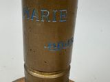 a close up of a brass object on a white surface