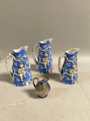 quatre pièces de poterie bleue et blanche ornées de motifs blancs