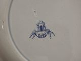 a blue and white plate with a picture of a castle on it