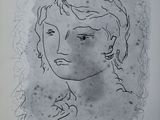 un dessin à l'encre représentant le visage d'une femme sur une feuille de papier