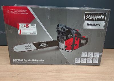 the box of a chainsaw is sitting on a wooden table