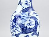 blue and white vase with a dragon design on it