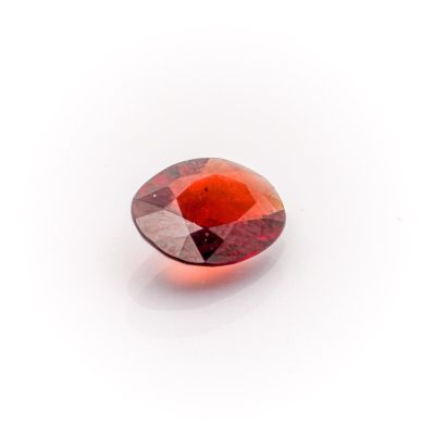a close up view of a red diamond on a white surface