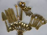 a lot of silverware on a white table