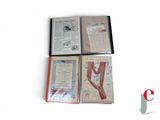 several books are lined up on a white surface with a red bookmark