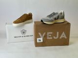 grey and white sneakers in a box on a white surface