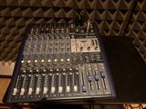 a sound board sitting on top of a table in a recording studio