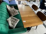 a green couch with pillows on it in a restaurant