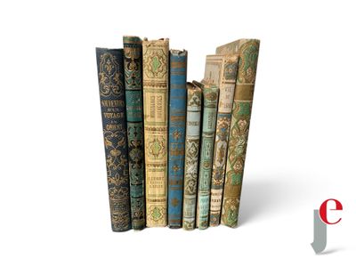 several old books are stacked on top of each other on a white surface