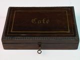 a close up of a wooden box on a white surface